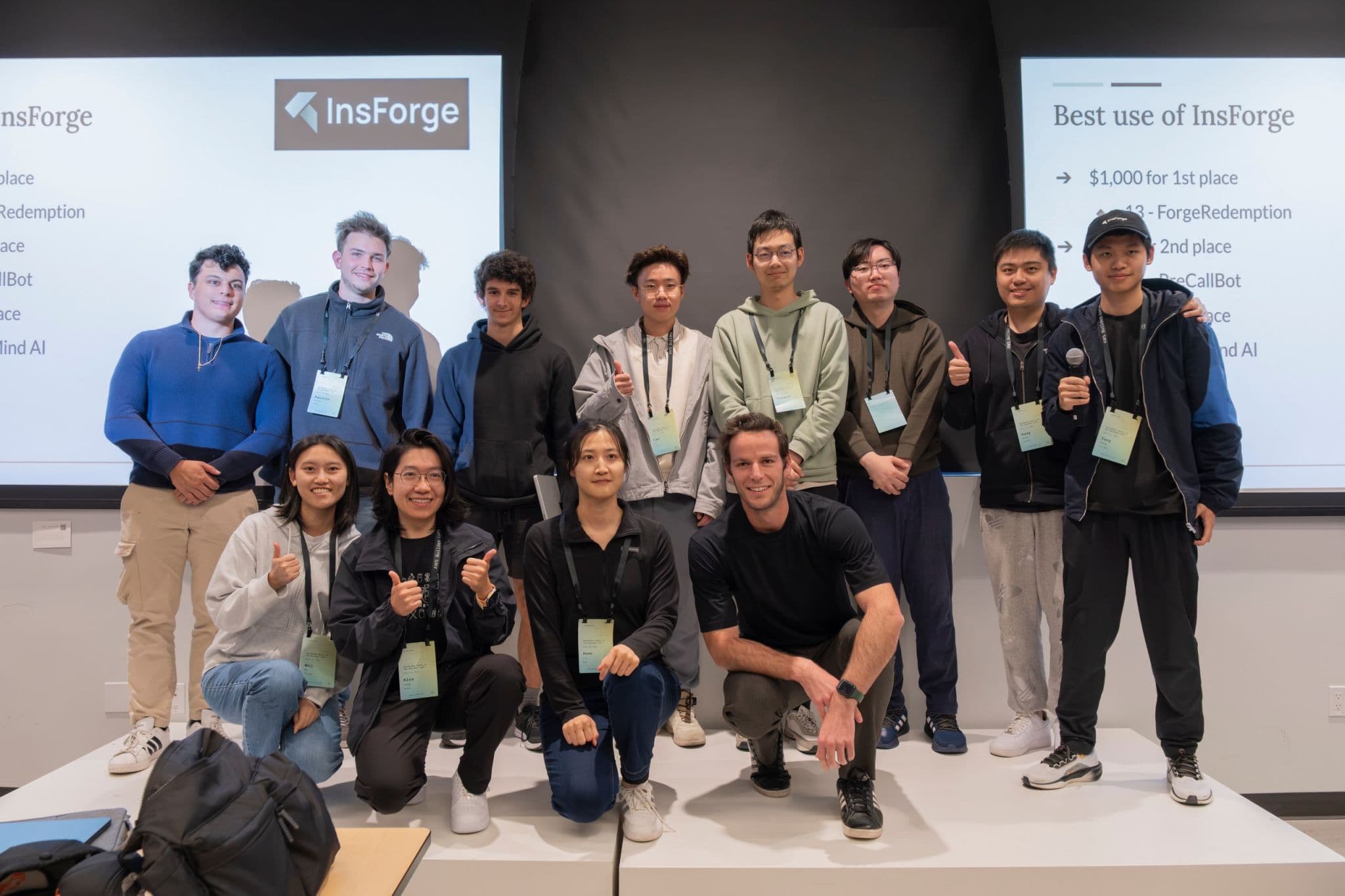 Hackathon winners posing together on stage after a prize announcement.